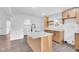 A kitchen island with stainless sink and gooseneck faucet with wooden cabinets and quartz countertop at 1555 N Dearborn St, Indianapolis, IN 46201