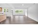 Bright living room featuring hardwood floors and large windows offering scenic outdoor views at 1555 N Dearborn St, Indianapolis, IN 46201
