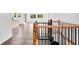 Wooden staircase with black metal spindles leads to an open-concept living room with large windows at 1555 N Dearborn St, Indianapolis, IN 46201