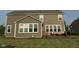 Back exterior of home, featuring a deck with outdoor seating, overlooking a lush lawn at 15961 Foothill Dr, Noblesville, IN 46060