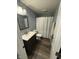 Modern bathroom with gray vanity, a stylish sink, and a shower/tub combination at 15961 Foothill Dr, Noblesville, IN 46060