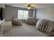 Spacious bonus room featuring a ceiling fan, large window, and comfortable beanbag seating at 15961 Foothill Dr, Noblesville, IN 46060