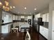 Modern kitchen featuring stainless steel appliances, granite countertops, a large island, and stylish pendant lighting at 15961 Foothill Dr, Noblesville, IN 46060