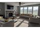 Cozy living room with a stone fireplace, large windows for natural light, and comfortable seating at 15961 Foothill Dr, Noblesville, IN 46060