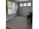 Bright office space with large windows, neutral walls, and a classic piano for added charm at 15961 Foothill Dr, Noblesville, IN 46060