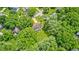 An overhead view displays a house surrounded by mature trees in a quiet residential neighborhood at 1660 Obara Ct, Carmel, IN 46033