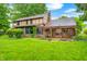 Beautifully landscaped backyard featuring mature trees, lush lawn, and outdoor seating area at 1660 Obara Ct, Carmel, IN 46033