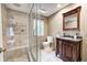 Elegant bathroom with a glass-enclosed shower, a dark wood vanity with granite top, and tile flooring at 1660 Obara Ct, Carmel, IN 46033
