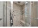 Detailed bathroom showcases a glass-enclosed shower with mosaic accents and a built-in bench, offering a luxurious experience at 1660 Obara Ct, Carmel, IN 46033