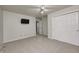 Neutral bedroom featuring a ceiling fan, closet and a wall-mounted tv at 1660 Obara Ct, Carmel, IN 46033