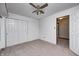 Carpeted bedroom with ceiling fan and closet ready for personalization at 1660 Obara Ct, Carmel, IN 46033