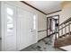 Inviting entryway with stone tile flooring, a classic front door, and staircase at 1660 Obara Ct, Carmel, IN 46033