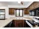 Traditional kitchen with wood cabinets, ample counter space, and a view of the outdoors at 1660 Obara Ct, Carmel, IN 46033