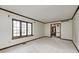 Bright living room featuring neutral carpet, classic trim, and large windows for natural light at 1660 Obara Ct, Carmel, IN 46033