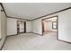 Spacious living room featuring neutral carpet, classic trim, and open access to adjacent rooms at 1660 Obara Ct, Carmel, IN 46033