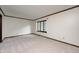 Large empty room with neutral carpet, classic trim, and a window providing natural light at 1660 Obara Ct, Carmel, IN 46033