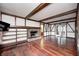 Spacious living room features a brick fireplace, wood beams, and hardwood floors at 1660 Obara Ct, Carmel, IN 46033