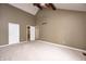 Large main bedroom featuring high ceilings, a ceiling fan, neutral carpet, and a view into an adjoining bathroom at 1660 Obara Ct, Carmel, IN 46033