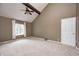 Spacious main bedroom with high ceilings, a ceiling fan, neutral carpet, and a large window providing ample natural light at 1660 Obara Ct, Carmel, IN 46033