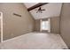 Bright main bedroom with vaulted ceilings, ceiling fan, neutral carpet, and large window, creating a comfortable retreat at 1660 Obara Ct, Carmel, IN 46033