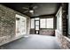 The sunroom features brick walls, backyard access, and multiple windows for natural light at 1660 Obara Ct, Carmel, IN 46033