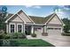 Charming single-Gathering home boasting a two-car garage and welcoming front yard with beautiful landscaping at 17030 Daly Dr, Noblesville, IN 46062