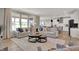 Open-concept living room with comfortable sofas, layered rugs, and an adjacent kitchen for easy entertaining at 17030 Daly Dr, Noblesville, IN 46062