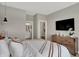 Serene primary bedroom showcasing access to the ensuite bathroom and a mounted television at 17030 Daly Dr, Noblesville, IN 46062