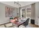 Well-lit home office with a wooden desk, modern lighting, and a large abstract painting on the wall at 17030 Daly Dr, Noblesville, IN 46062