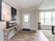 Welcoming entryway featuring wood floors, a stylish console table, contemporary art, and plenty of natural light at 17050 Daly Dr, Noblesville, IN 46062