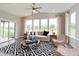 Inviting sunroom with large windows, stylish seating, and a decorative black-and-white rug at 17050 Daly Dr, Noblesville, IN 46062