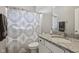 Well-lit bathroom with granite countertops, patterned shower curtain, and modern fixtures at 2105 Granville Dr, Westfield, IN 46074