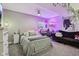 This spacious bedroom is illuminated with soft purple lighting, creating a cozy and whimsical atmosphere at 2105 Granville Dr, Westfield, IN 46074