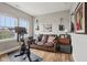 Bonus room features a cozy brown leather sofa with a window and guitars decorating the wall at 2105 Granville Dr, Westfield, IN 46074