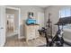 Relaxing bonus room with a peloton bike, hardwood floors, and natural light from a window at 2105 Granville Dr, Westfield, IN 46074