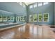 Bright fitness area with hardwood floors, tall ceilings, large mirror and many windows overlooking the beautiful landscaping at 2105 Granville Dr, Westfield, IN 46074
