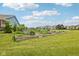 Community garden with several raised garden beds and a charming view of the neighborhood homes at 2105 Granville Dr, Westfield, IN 46074
