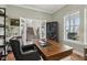 Bright home office offers a large wooden desk with a leather office chair and windows providing natural light at 2105 Granville Dr, Westfield, IN 46074
