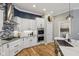 Modern kitchen featuring white cabinets, stainless steel appliances, granite countertops, and hardwood floors at 2105 Granville Dr, Westfield, IN 46074