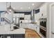 Updated kitchen with stainless appliances, white cabinets, island with breakfast bar, and hardwood floors at 2105 Granville Dr, Westfield, IN 46074