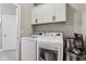 Bright laundry room with white washer and dryer, white cabinets, and storage space at 2105 Granville Dr, Westfield, IN 46074