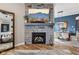 Inviting living room features a stone fireplace, mounted TV, and seamless view to the dining area at 2105 Granville Dr, Westfield, IN 46074