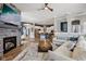 Open-concept living room with stone fireplace, hardwood floors, and seamless access to a modern kitchen at 2105 Granville Dr, Westfield, IN 46074
