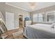Comfortable bedroom with hard wood floors, large windows, and a view to the en-suite bathroom at 2105 Granville Dr, Westfield, IN 46074