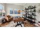 Stylish home office with hardwood floors, industrial-style shelving, and comfortable seating at 2105 Granville Dr, Westfield, IN 46074