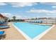 Relaxing community pool on a sunny day with blue lounge chairs and white fence at 2105 Granville Dr, Westfield, IN 46074