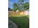 Backyard featuring a lush lawn, a newly installed wood fence, and shade trees, ideal for outdoor activities at 2170 S East St, Indianapolis, IN 46225