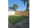 Backyard featuring a lush lawn, a newly installed wood fence, and mature trees, perfect for relaxation at 2170 S East St, Indianapolis, IN 46225