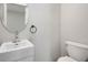 Updated half-bathroom features a pedestal sink, modern fixtures, and neutral paint at 2170 S East St, Indianapolis, IN 46225