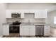Modern kitchen featuring stainless steel appliances, granite countertops, and ample cabinet space at 2170 S East St, Indianapolis, IN 46225